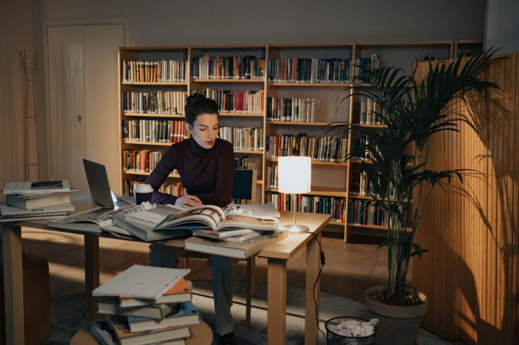 a woman sitting on a chair while working at night