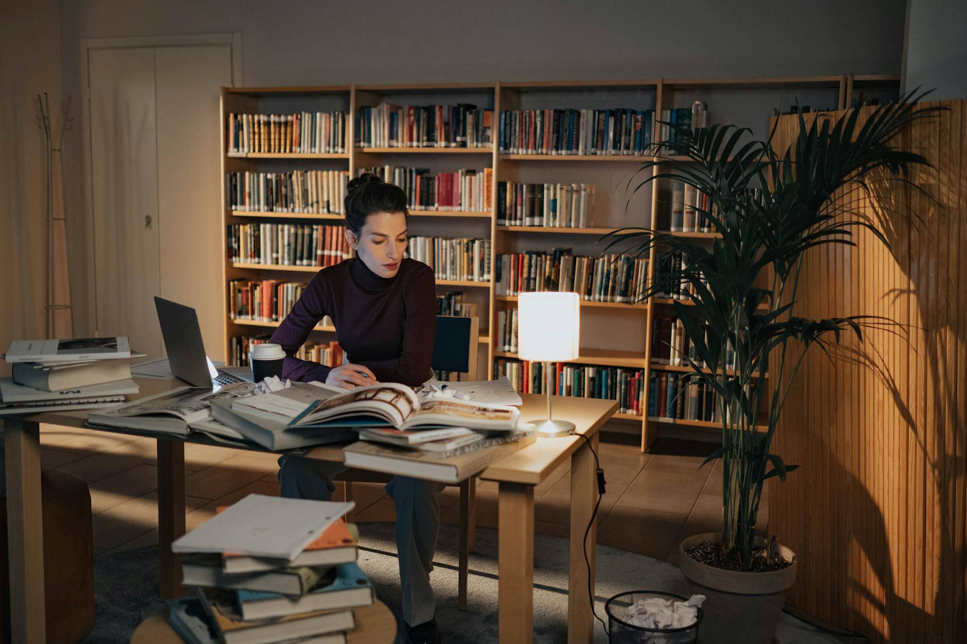 a woman sitting on a chair while working at night