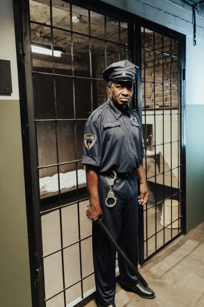 man in blue uniform holding black stick