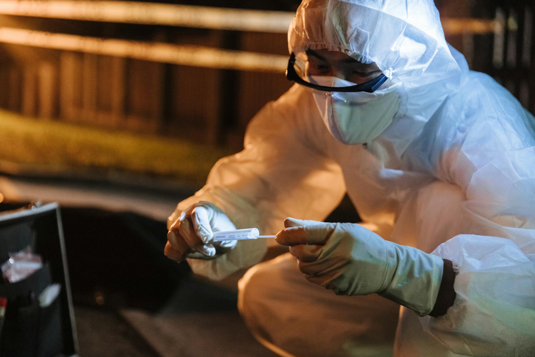 forensics investigator taking samples from a crime scene