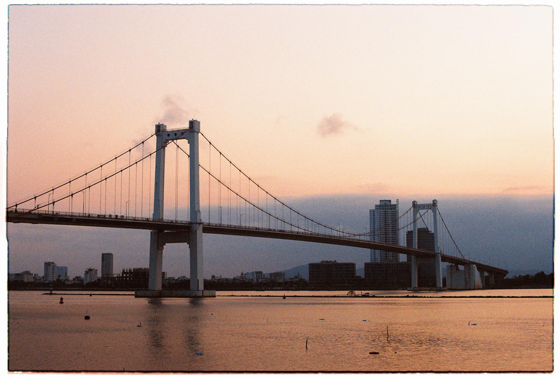 rainbow bridge on sea coast in tokyo at sunset