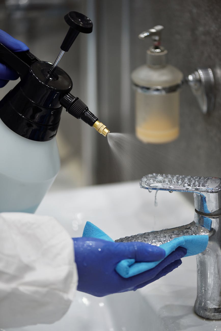 person cleaning the faucet