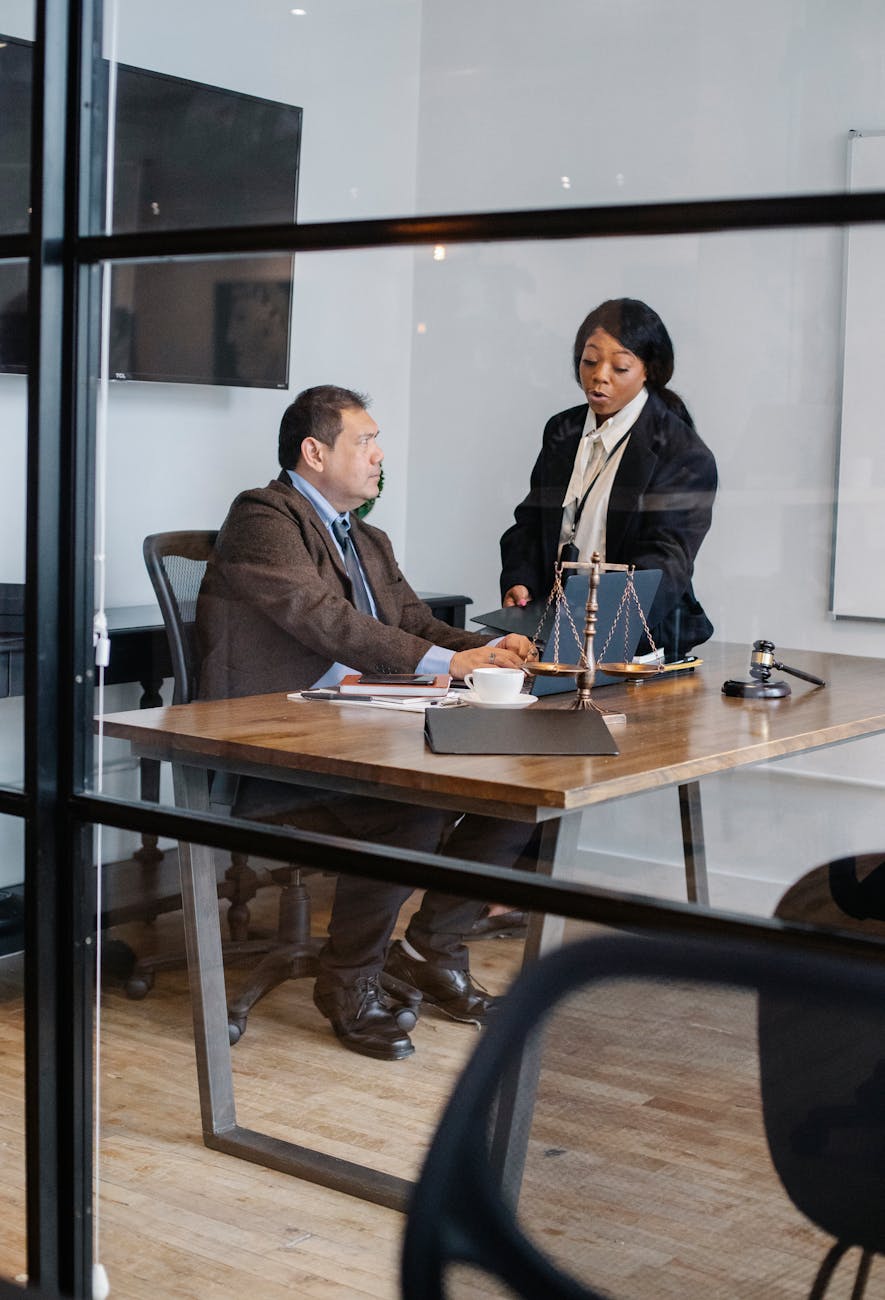 female secretary talking with boss in lawyer office