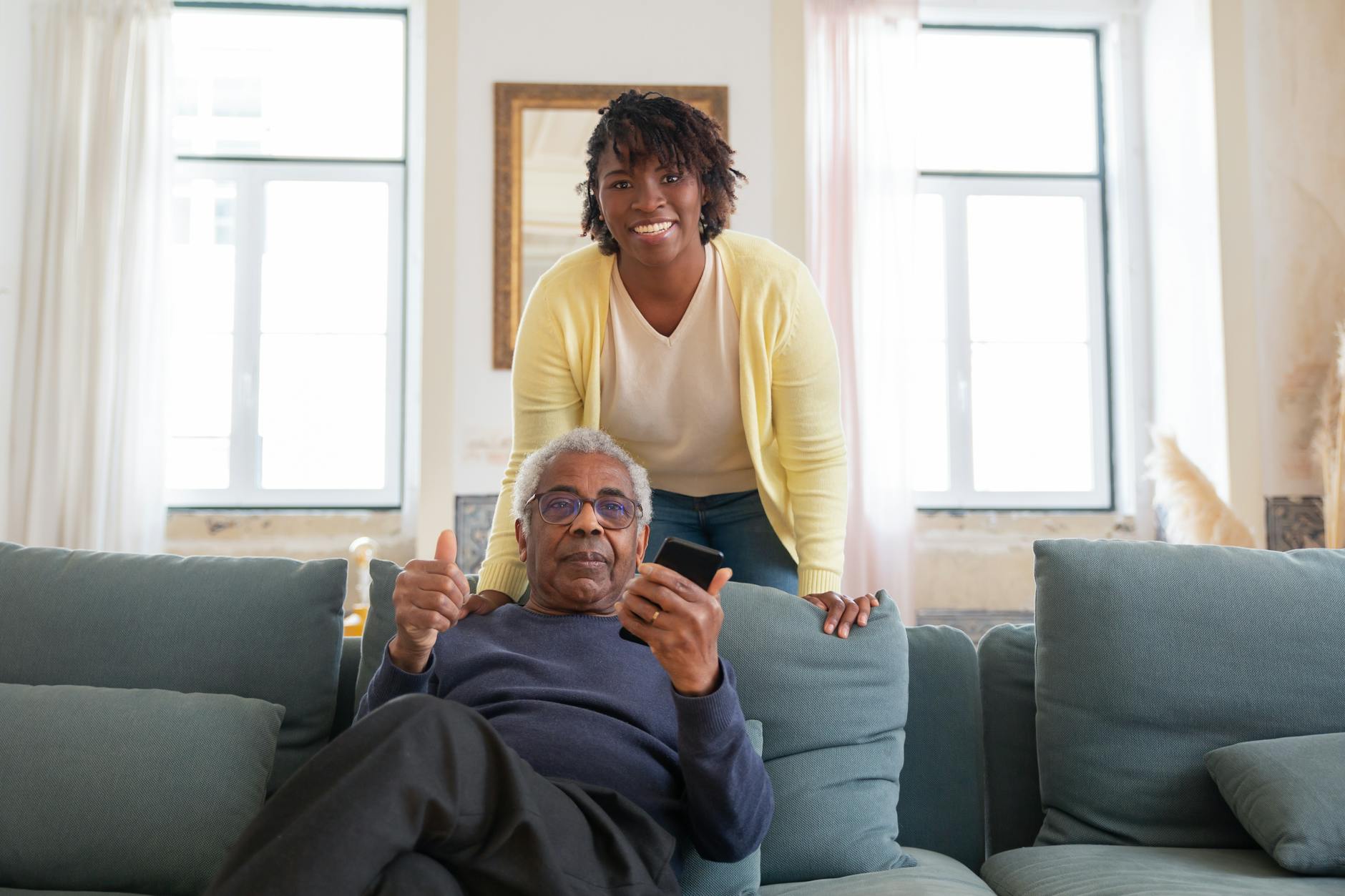 a man in blue sweater sitting on blue sofa