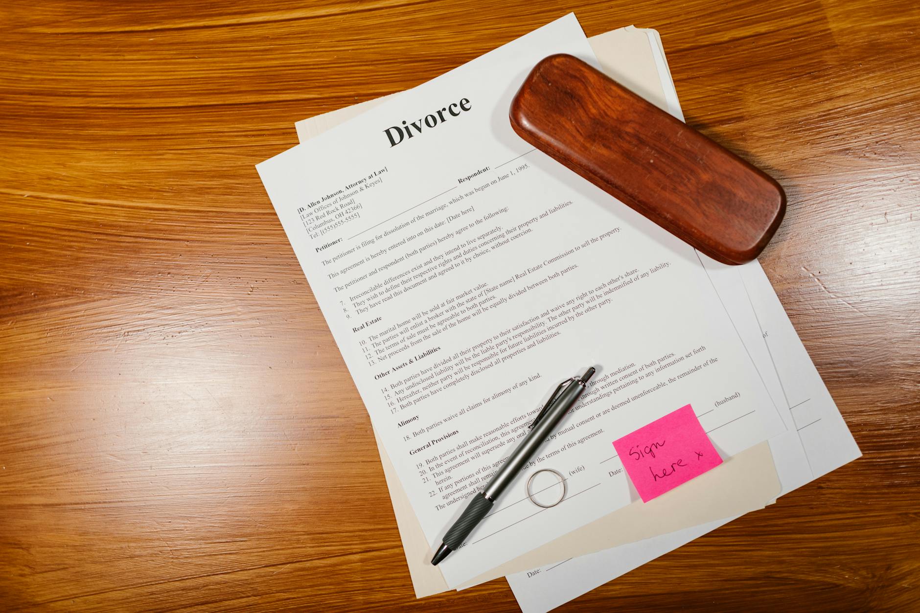 a divorce paper with pen on a wooden floor