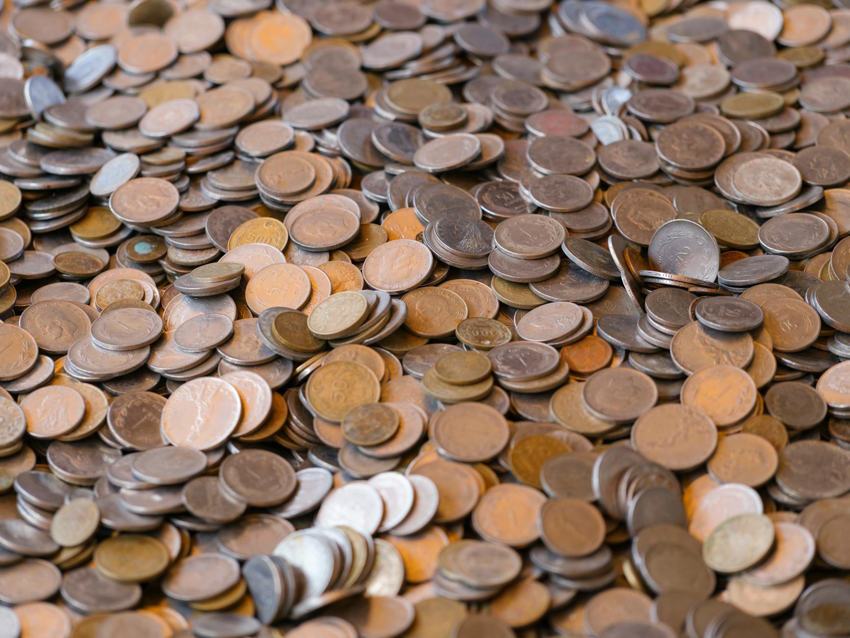 abundance of coins depicting wealth and finance