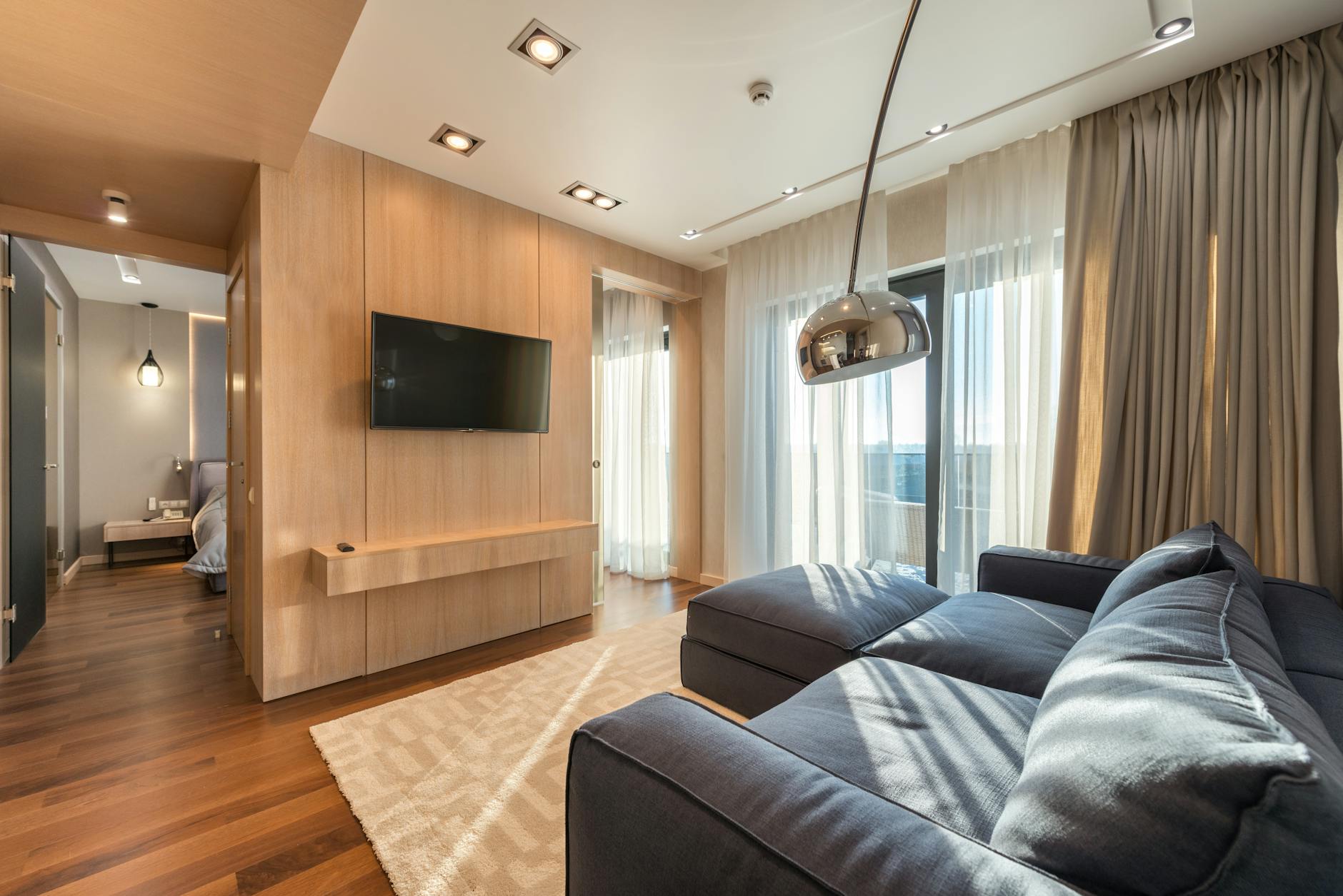 spacious apartment with living room and bedroom and wooden furniture