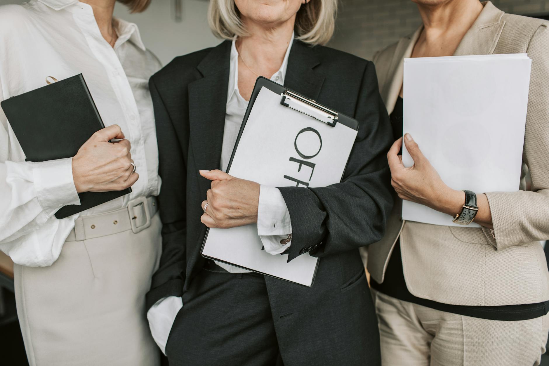 close up shot of businesswomen holding documents