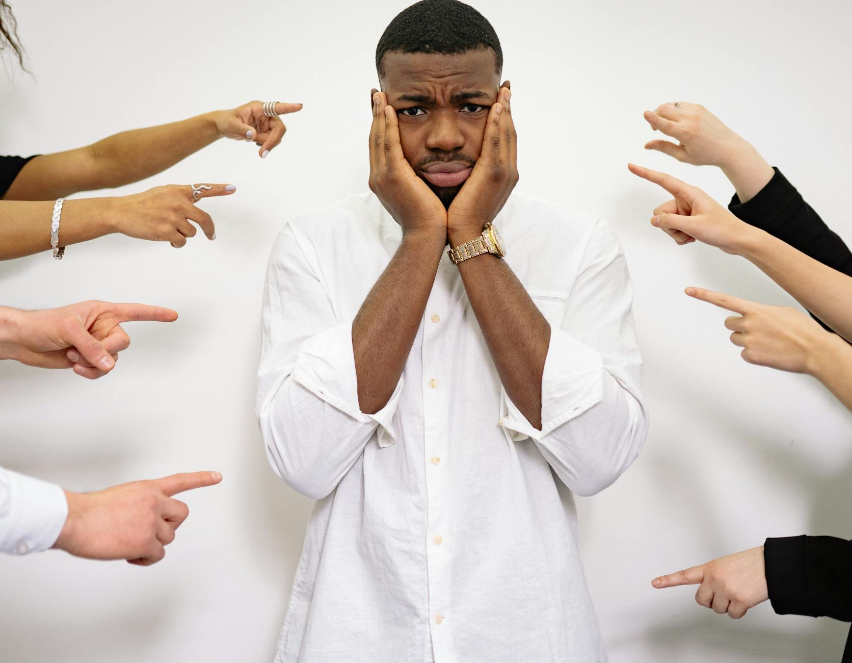 a man holding his face