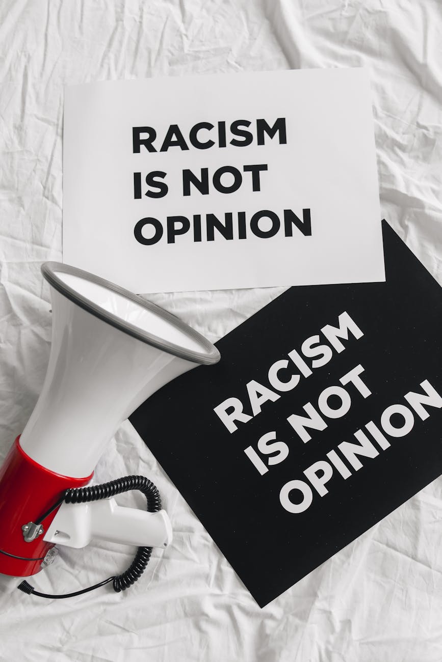 megaphone and placards on racism on white linen