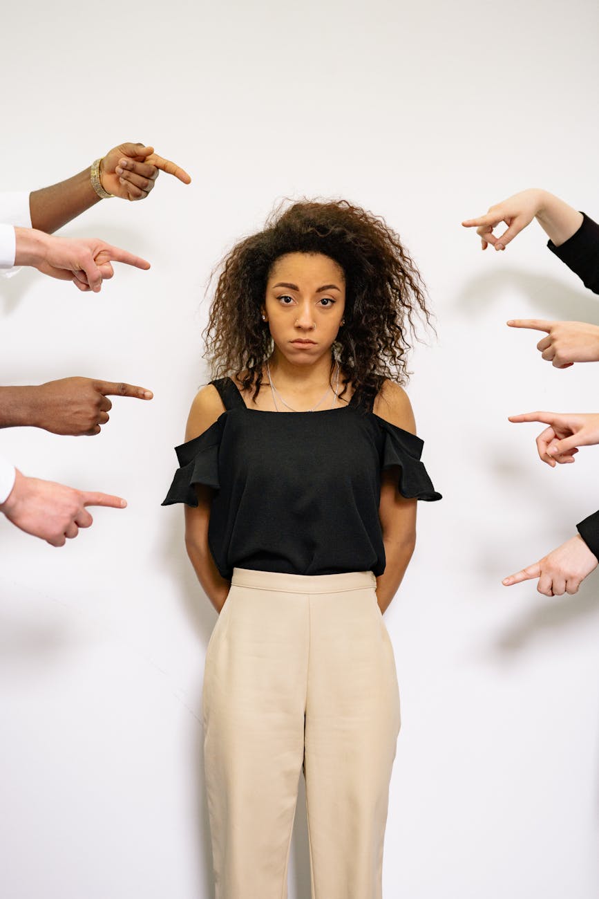 people pointing fingers at a stressed woman